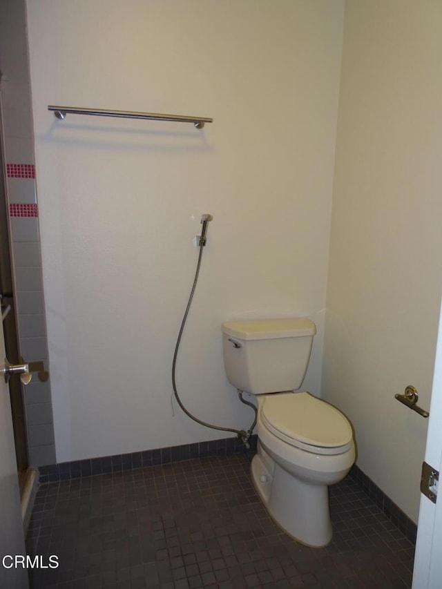 bathroom featuring tile patterned flooring and toilet