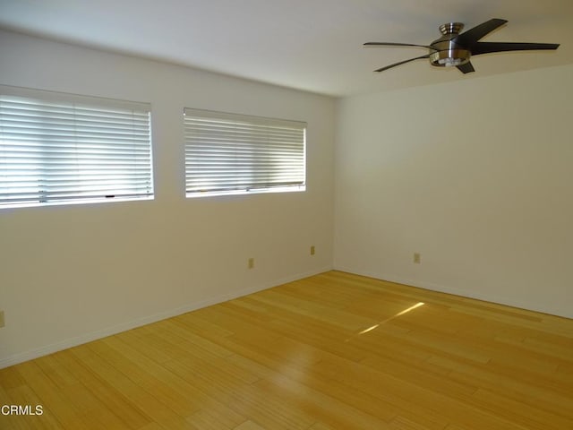 spare room featuring ceiling fan and light wood-type flooring