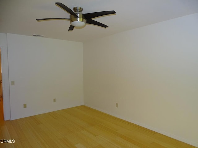 spare room with ceiling fan and light wood-type flooring