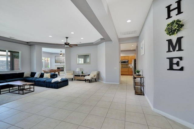 tiled living room featuring ceiling fan