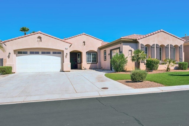 mediterranean / spanish home with a garage