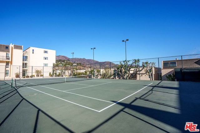 view of tennis court with a mountain view