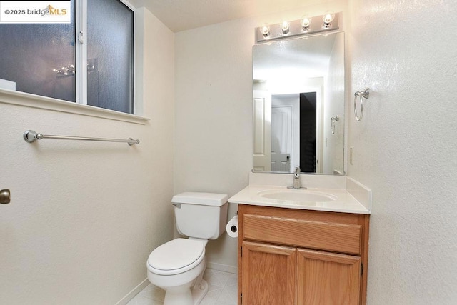 bathroom featuring tile patterned floors, toilet, and vanity