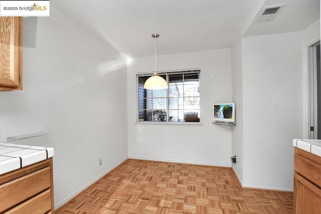 dining space featuring light parquet floors