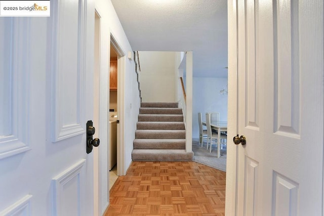 interior space featuring washer / clothes dryer and light carpet