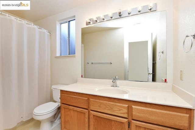 bathroom featuring tile patterned floors, vanity, and toilet