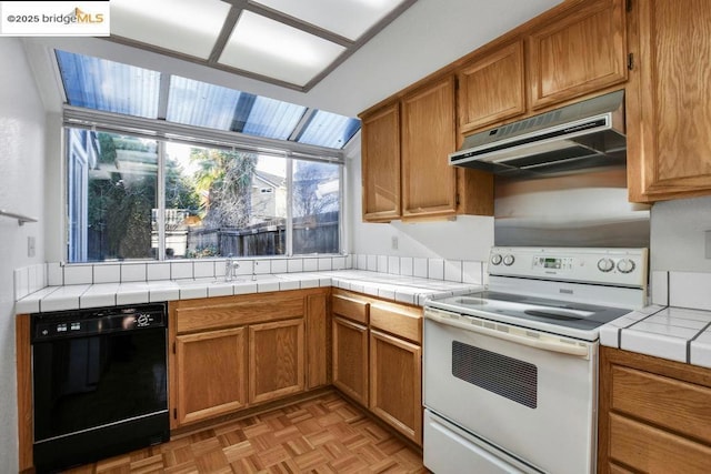 kitchen featuring white electric range, tile countertops, dishwasher, and light parquet floors