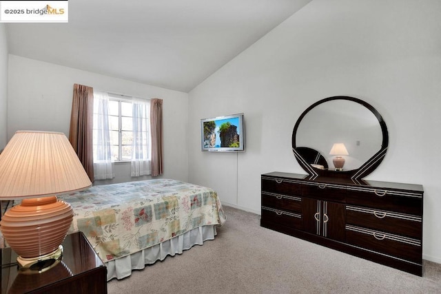 carpeted bedroom featuring lofted ceiling