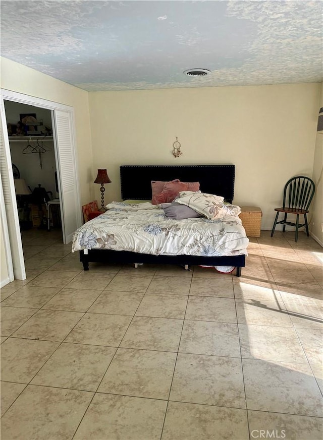 bedroom featuring a closet and light tile patterned flooring