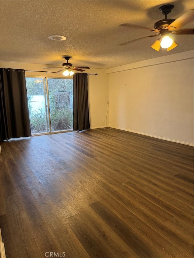 empty room with ceiling fan, a textured ceiling, and dark hardwood / wood-style flooring