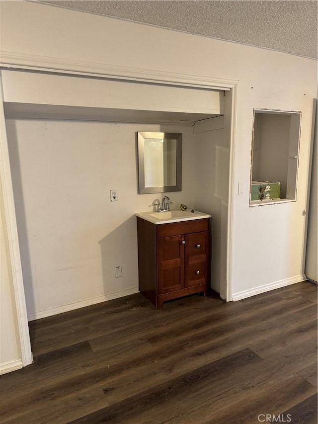 bathroom with vanity, wood-type flooring, and a textured ceiling