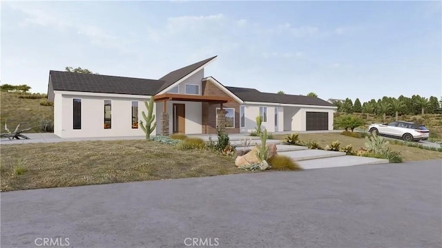 view of front of house featuring a garage and a front lawn