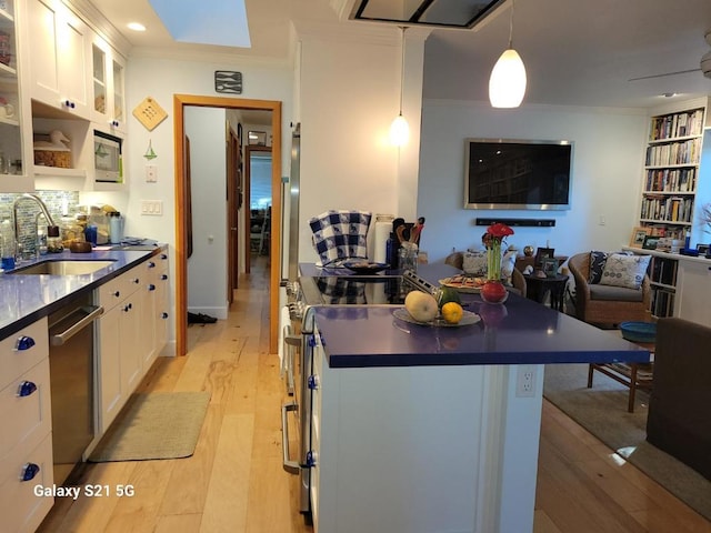 kitchen with crown molding, light hardwood / wood-style floors, sink, and white cabinets