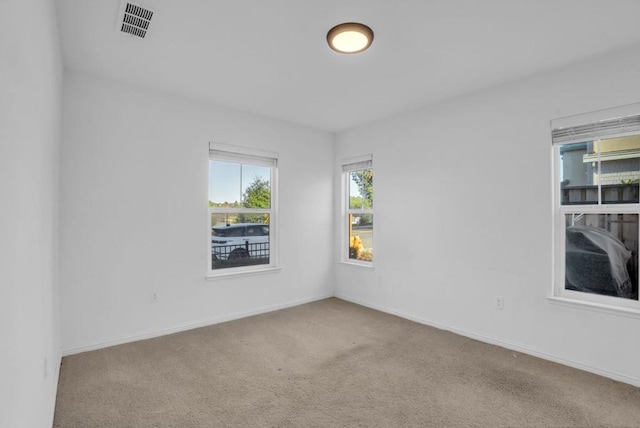 unfurnished room with light carpet