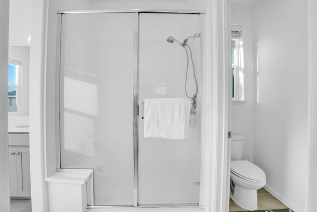 bathroom featuring walk in shower, vanity, and toilet