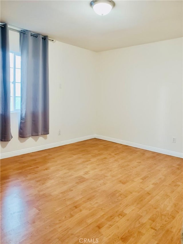 spare room featuring light wood-type flooring