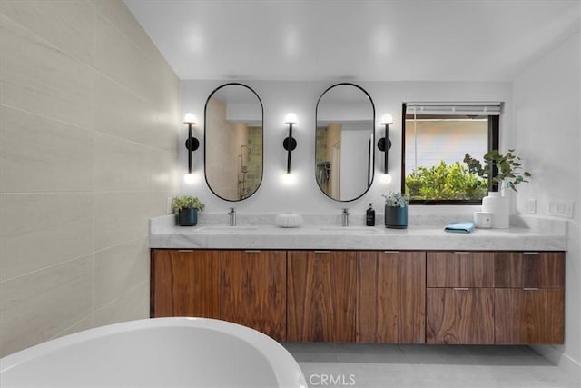 bathroom with vanity, a bathing tub, and tile walls