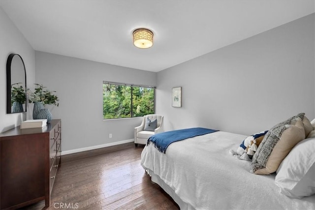 bedroom with dark hardwood / wood-style floors