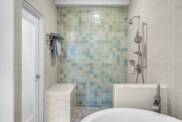 bathroom with tile walls and a tile shower