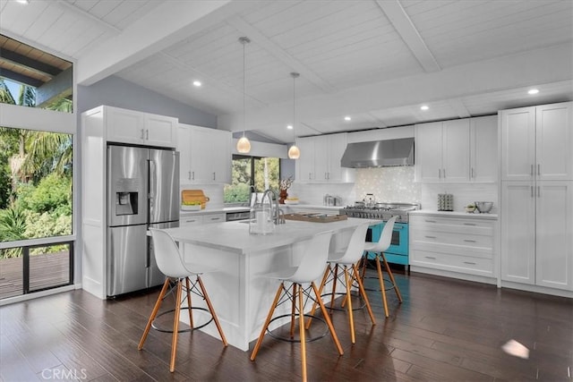 kitchen with white cabinetry, wall chimney range hood, stainless steel fridge with ice dispenser, and stove