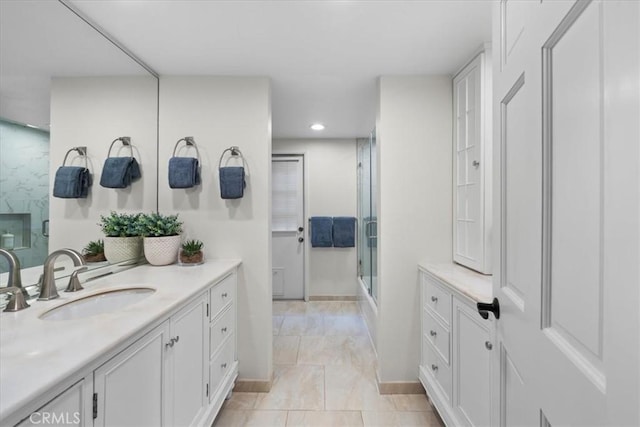 bathroom with vanity and an enclosed shower