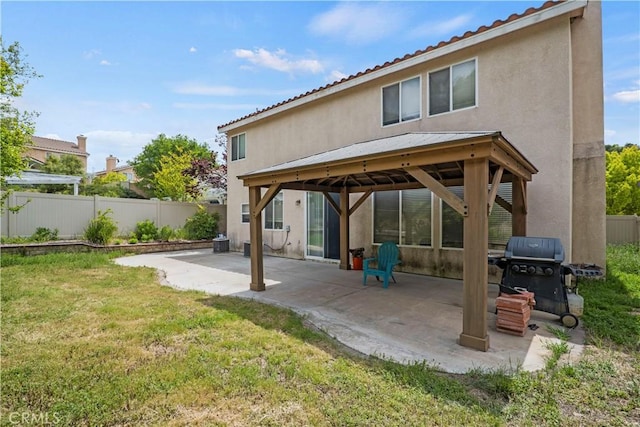 back of house featuring a yard and a patio area