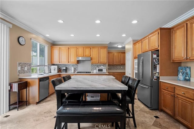 kitchen featuring ornamental molding, appliances with stainless steel finishes, sink, and decorative backsplash