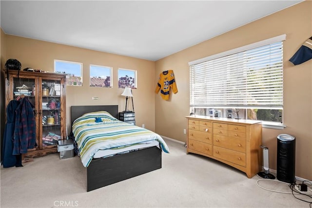 carpeted bedroom featuring multiple windows