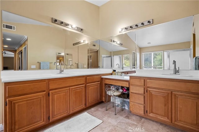 bathroom featuring vaulted ceiling, ornamental molding, and vanity