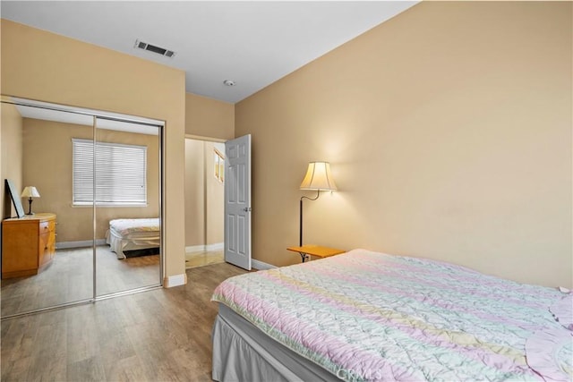 bedroom with hardwood / wood-style flooring and a closet