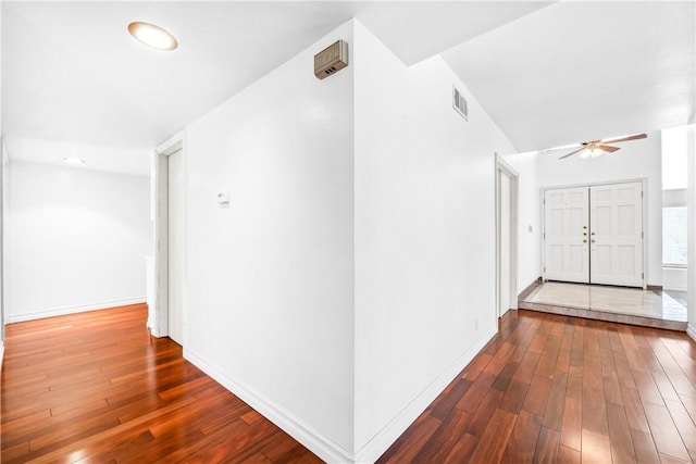 corridor with wood-type flooring