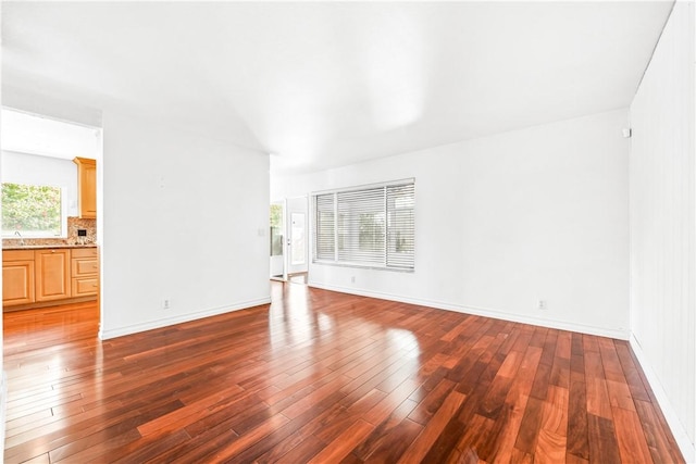 unfurnished living room featuring dark hardwood / wood-style floors