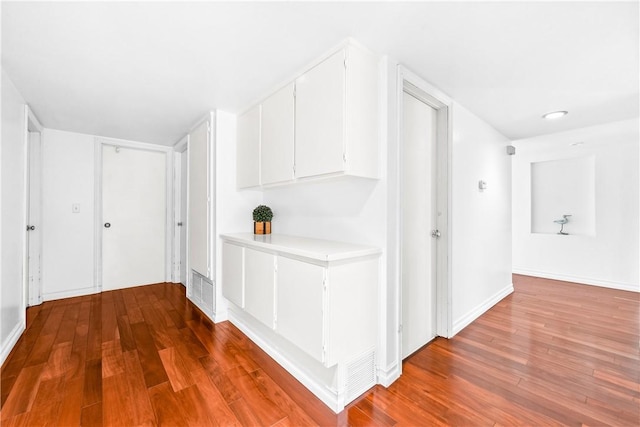 corridor featuring hardwood / wood-style floors