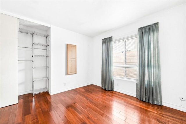 unfurnished room with hardwood / wood-style flooring