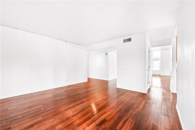 spare room with dark hardwood / wood-style floors