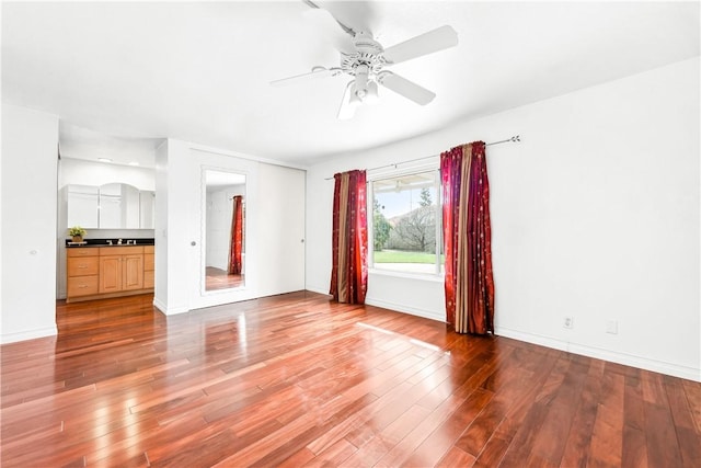 spare room with hardwood / wood-style floors and ceiling fan