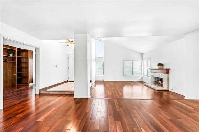 unfurnished living room featuring wood-type flooring and vaulted ceiling