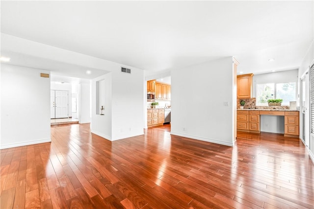 unfurnished living room with hardwood / wood-style flooring