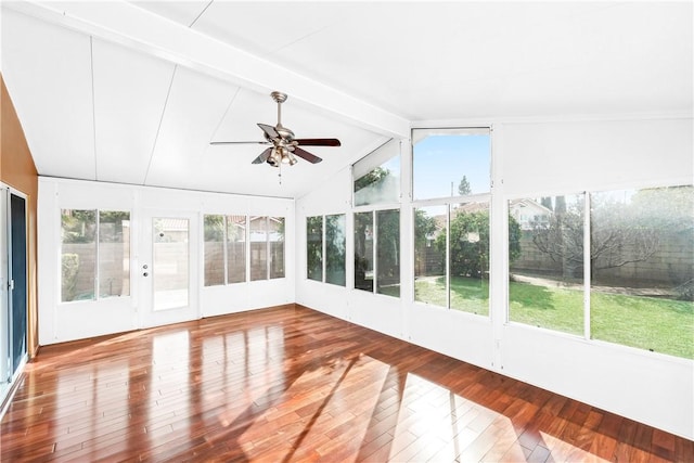 unfurnished sunroom featuring ceiling fan and vaulted ceiling with beams