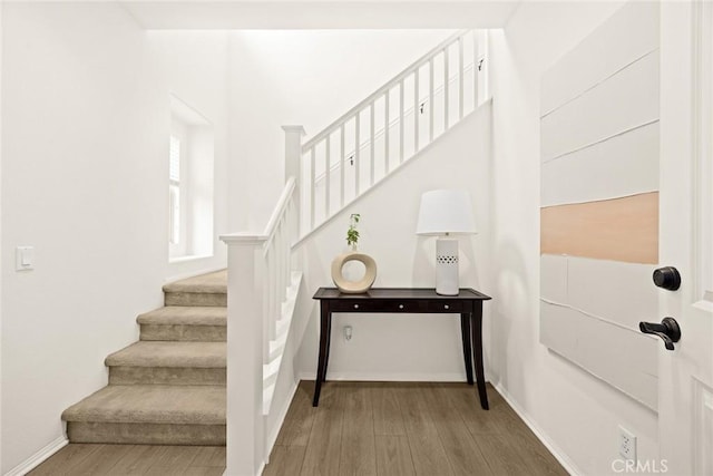 stairs featuring wood-type flooring