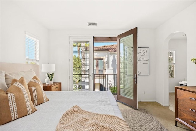 bedroom featuring light colored carpet and access to exterior