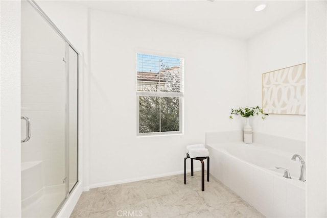 bathroom featuring tile patterned floors and separate shower and tub