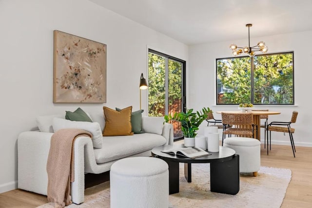 living room featuring an inviting chandelier and light hardwood / wood-style floors