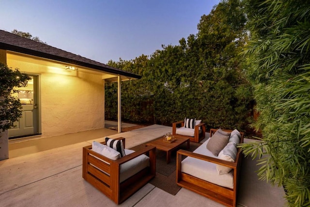 patio terrace at dusk featuring an outdoor hangout area