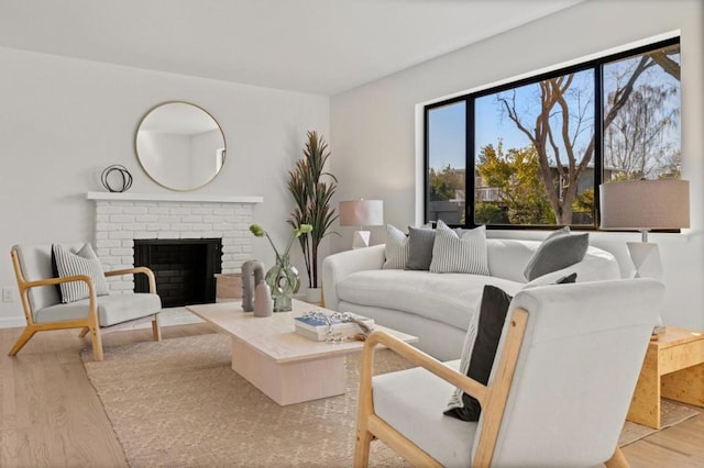 living room featuring a fireplace and light wood-type flooring