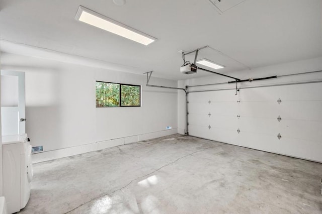 garage with washer / clothes dryer and a garage door opener