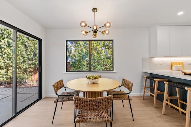 dining area featuring an inviting chandelier and light hardwood / wood-style floors