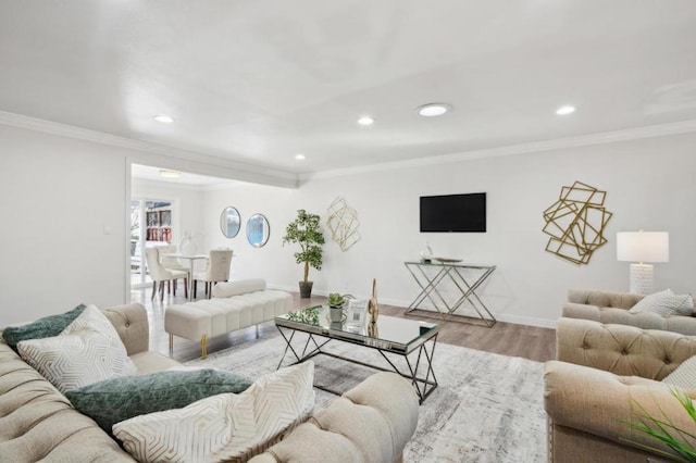 living room featuring ornamental molding and light hardwood / wood-style floors