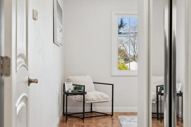 living area with a healthy amount of sunlight and light hardwood / wood-style flooring