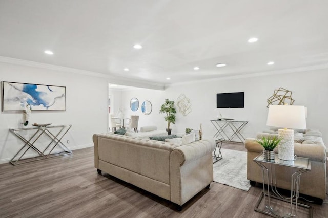 living room featuring wood-type flooring and ornamental molding